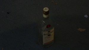 An empty bottle of liquor right outside my door